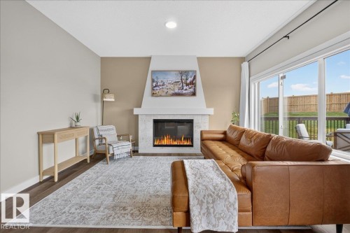 Living room - 347 Bluff Cove, Leduc, AB - Indoor Photo Showing Living Room With Fireplace