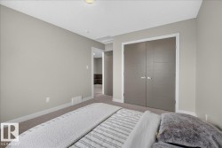Carpeted room with light grey walls, white trim, and a textured ceiling - 