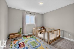 Neutral-toned room featuring a recessed ceiling light, a double window with drapes, and carpeted flooring - 
