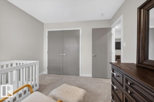 Soft gray walls complement the neutral carpeting in this room featuring a closet with bi-fold doors - 347 Bluff Cove, Leduc, AB - Indoor Photo Showing Bedroom