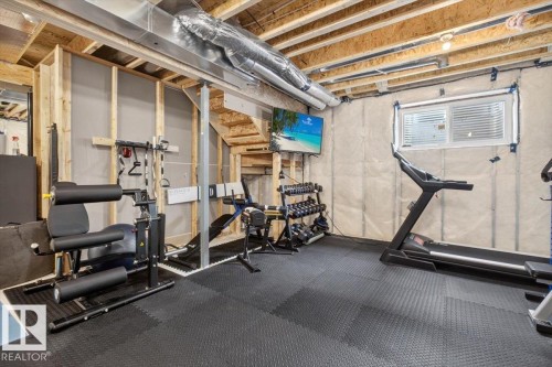Unfinished basement space featuring exposed wood framing, ceiling joists, and ductwork - 347 Bluff Cove, Leduc, AB - Indoor
