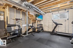 Unfinished basement space featuring exposed wood framing, ceiling joists, and ductwork - 