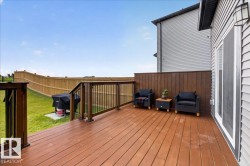 Expansive wood deck with dark stained flooring and railings - 