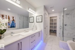Spacious bathroom featuring a double vanity with ample counter space, built-in cabinetry, and under-cabinet lighting - 