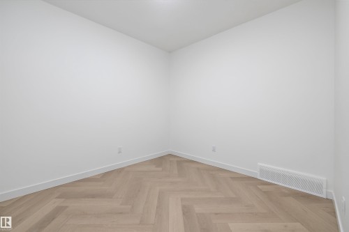 Wood-finish flooring in a herringbone pattern with crisp white walls - 1776 Crossbill Loop Nw, Edmonton, AB 