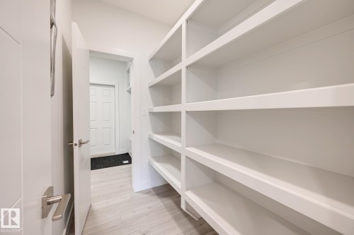 Custom built-in shelving with multiple levels of storage - 1776 Crossbill Loop Nw, Edmonton, AB - Indoor With Storage