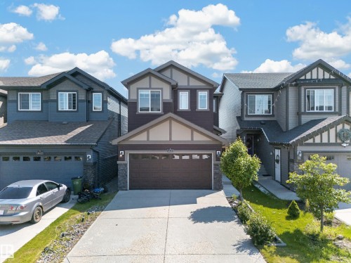 Two-story residence featuring a two-car attached garage with a concrete driveway - 4620 Alwood Way Sw, Edmonton, AB - Outdoor With Facade