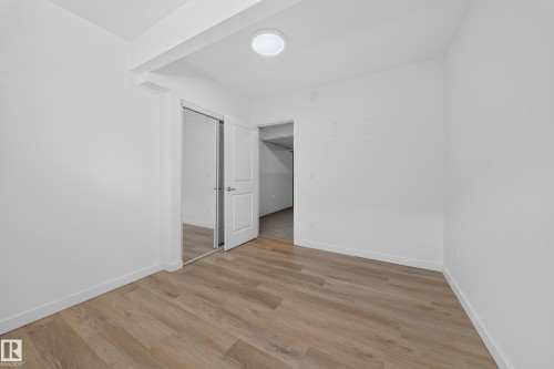 Bright room featuring light wood-finish flooring and crisp white walls - 4620 Alwood Way Sw, Edmonton, AB - Indoor Photo Showing Other Room