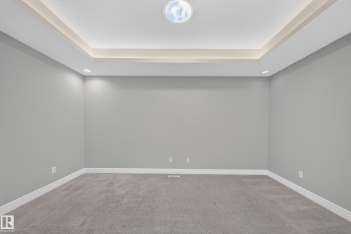 Tray ceiling with integrated lighting and recessed lighting fixtures - 4620 Alwood Way Sw, Edmonton, AB - Indoor Photo Showing Other Room