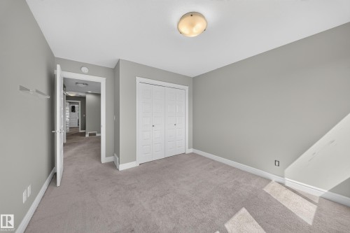 Carpeted room with light gray walls, white trim, and a flush-mount ceiling light - 4620 Alwood Way Sw, Edmonton, AB - Indoor Photo Showing Other Room