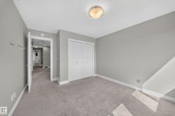 Carpeted room with light gray walls, white trim, and a flush-mount ceiling light - 