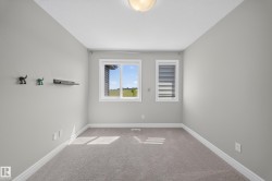 Neutral wall finishes complemented by light grey carpet - 