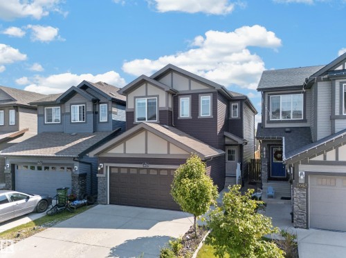 Two-story residence featuring a multi-tone exterior with dark siding, light trim, and stone accents - 4620 Alwood Way Sw, Edmonton, AB - Outdoor With Facade