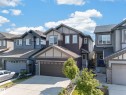 Two-story residence featuring a multi-tone exterior with dark siding, light trim, and stone accents - 4620 Alwood Way Sw, Edmonton, AB  - Outdoor With Facade 