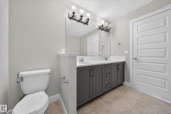 Double vanity with gray cabinetry and white countertops - 