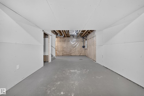 Unfinished basement offering expansive open space, concrete flooring, exposed ceiling joists, and visible insulation, providing a blank canvas for customization - 4620 Alwood Way Sw, Edmonton, AB - Indoor
