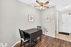 Warm wood-finish flooring complements light gray walls - 