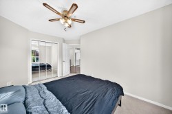 Room featuring light gray painted walls, carpet flooring, a ceiling fan with integrated lighting, and a mirrored closet - 