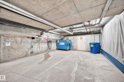 Concrete floor and wall surfaces with exposed overhead piping - 