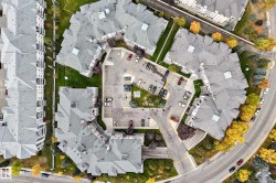 Aerial perspective showcasing multiple residential buildings with gray roofs - 