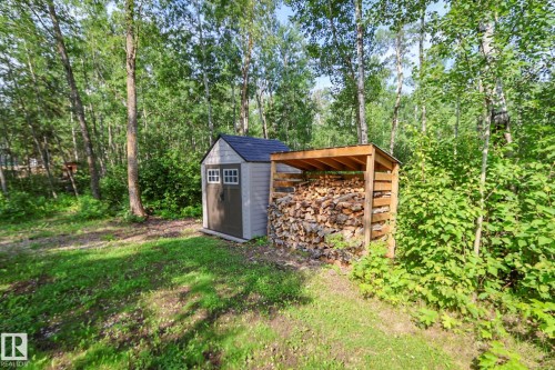 Utility shed with shingled roof, double doors, and decorative windows - 200 12272 Township Road 602, Rural Smoky Lake County, AB 