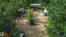 Wooded property featuring a gravel drive, a shed with a metal roof, and a small cabin with a dark metal roof - 200 12272 Township Road 602, Rural Smoky Lake County, AB 