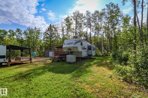 Expansive wooded property featuring a cleared grassy area - 200 12272 Township Road 602, Rural Smoky Lake County, AB 