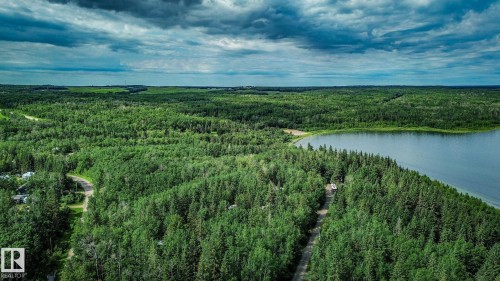 Expansive wooded acreage bordering a tranquil lake - 200 12272 Township Road 602, Rural Smoky Lake County, AB 
