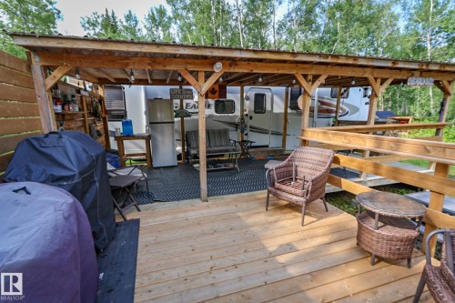 Expansive wooden deck featuring a covered pergola structure - 200 12272 Township Road 602, Rural Smoky Lake County, AB 