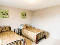 Carpeted room featuring light beige wall paint and a flush-mount ceiling light fixture - 