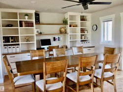 Integrated built-in shelving and cabinetry with a light wood-finish countertop - 