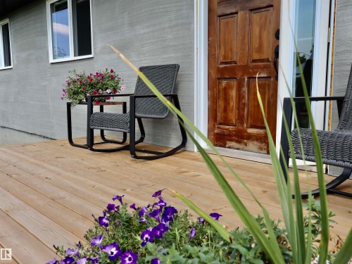 Expansive wood-finish deck with a textured exterior facade - 62503A Hwy 769, Rural Barrhead County, AB - Outdoor With Exterior
