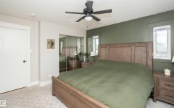 Bedroom featuring a ceiling fan, a mirrored closet, recessed lighting, and two windows - 