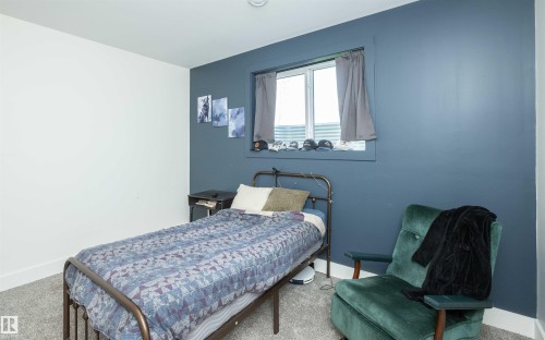 Carpeted room with a window featuring a white frame - 62503A Hwy 769, Rural Barrhead County, AB - Indoor Photo Showing Bedroom