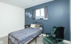 Carpeted room with a window featuring a white frame - 