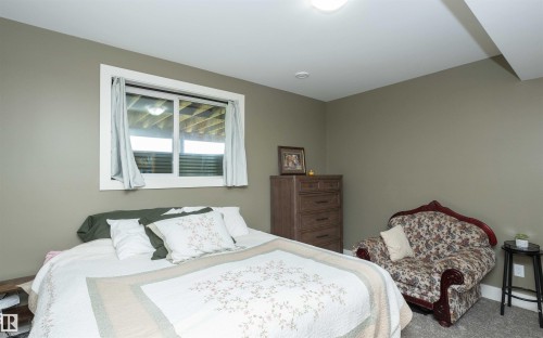 Bedroom featuring a white framed window, recessed lighting, and a built-in overhead light fixture - 62503A Hwy 769, Rural Barrhead County, AB - Indoor Photo Showing Bedroom