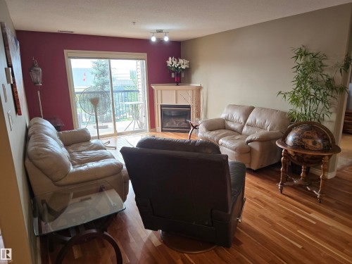 #337 2096 Blackmud Creek Dr Sw, Edmonton, AB - Indoor Photo Showing Living Room With Fireplace