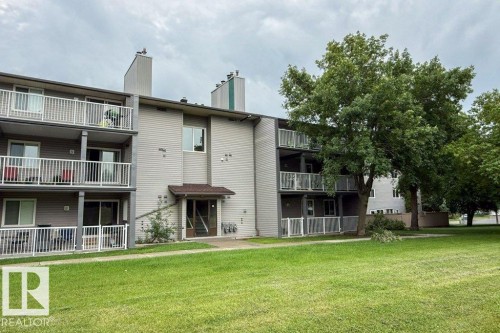 Multi-story building featuring light-colored siding and individual balconies/patios - #307 6212 180 St Nw, Edmonton, AB - Outdoor