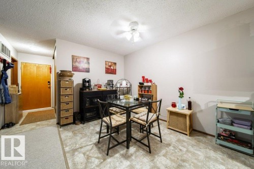Dining area featuring stone-look flooring, a ceiling fan, and a light-colored wall palette - #307 6212 180 St Nw, Edmonton, AB - Indoor Photo Showing Office