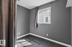 Windowed room featuring dark gray walls and white trim - 
