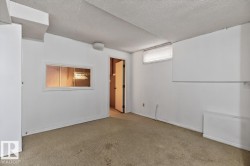 White walls with wall-to-wall carpeting, a small transom window, and a pass-through window with interior lighting - 