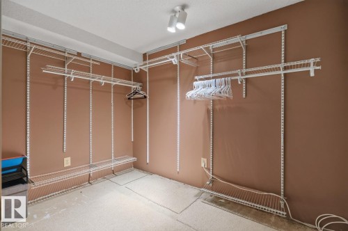 Walk-in closet featuring adjustable wire shelving and hanging rods - 4003 41 Avenue Nw, Edmonton, AB - Indoor