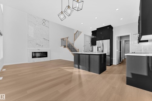 41 Axelwood Crescent, Spruce Grove, AB - Indoor Photo Showing Kitchen With Fireplace