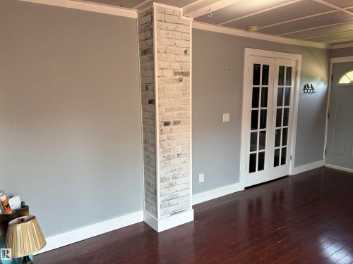 Interior space featuring hard wood flooring, light gray walls, and white trim - 4620 Maria Drive, Smoky Lake Town, AB - Indoor Photo Showing Other Room