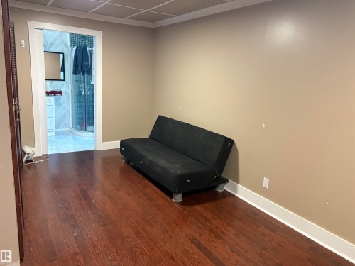 Hardwood-finish flooring, neutral wall paint, and white baseboards - 4620 Maria Drive, Smoky Lake Town, AB - Indoor Photo Showing Other Room