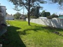 Spacious backyard featuring a wood fence, mature tree, and a grass lawn - 4620 Maria Drive, Smoky Lake Town, AB  - Outdoor 