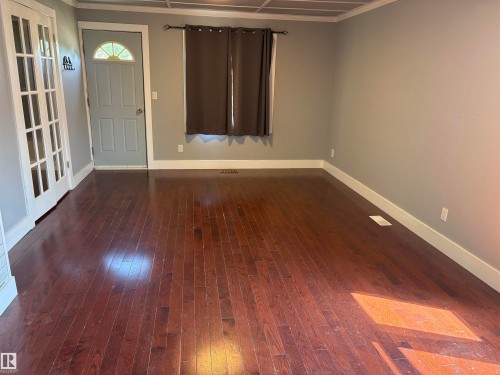 Hardwood-style flooring extends throughout this room, complemented by neutral wall tones - 4620 Maria Drive, Smoky Lake Town, AB - Indoor Photo Showing Other Room