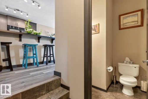 Kitchenette bar area with gray wood-finish flooring and track lighting - 3627 12 Street Nw, Edmonton, AB - Indoor Photo Showing Bathroom