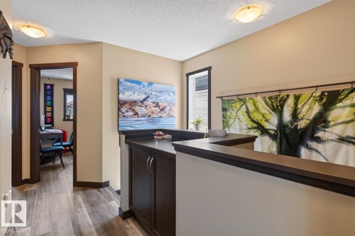 Hallway featuring wood-finish flooring and neutral wall tones - 3627 12 Street Nw, Edmonton, AB - Indoor Photo Showing Other Room