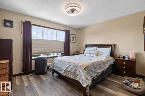 Spacious room featuring wood-finish flooring and neutral wall tones - 3627 12 Street Nw, Edmonton, AB - Indoor Photo Showing Bedroom